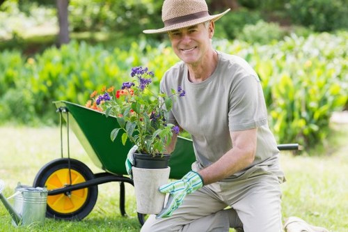 Worker following safe manual handling practices in the garden